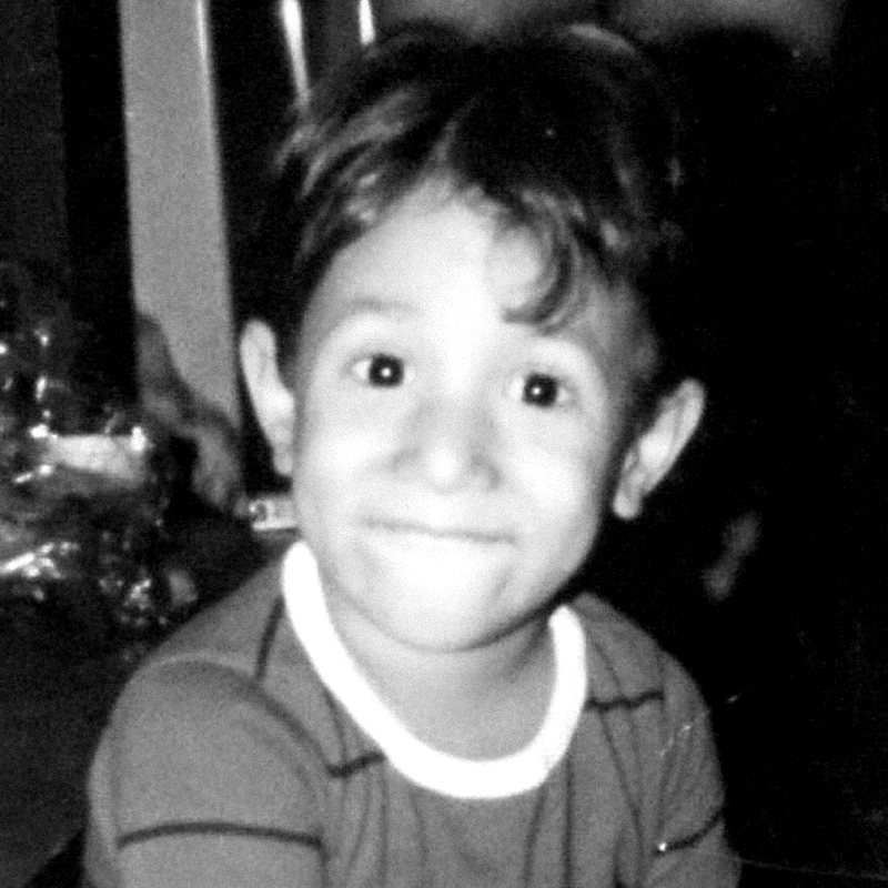 Guy as a small boy, smiling at the camera. Black and white.